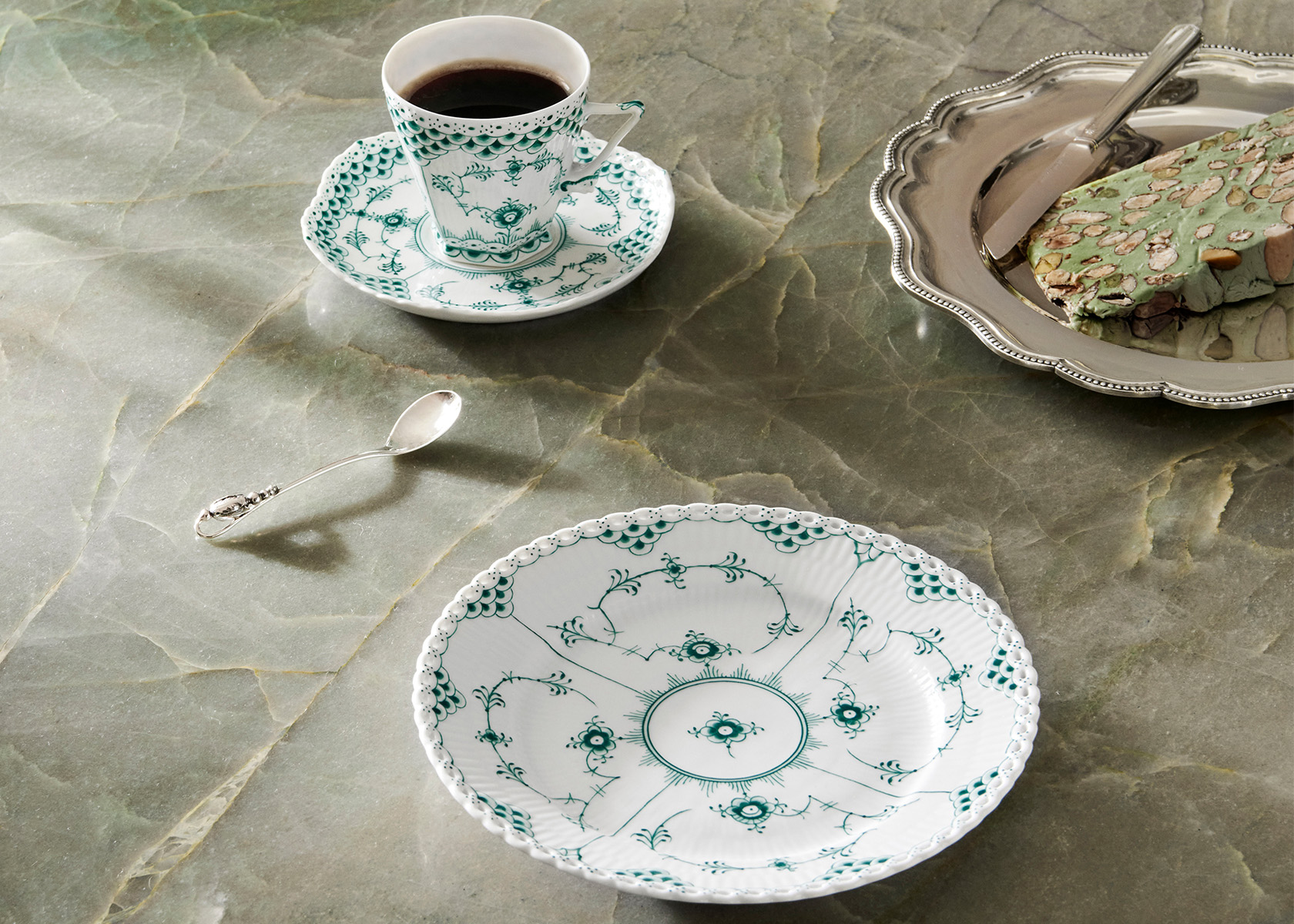 The handcrafted and hand-painted Emerald Fluted Full Lace te cup with sauser and dessert plate